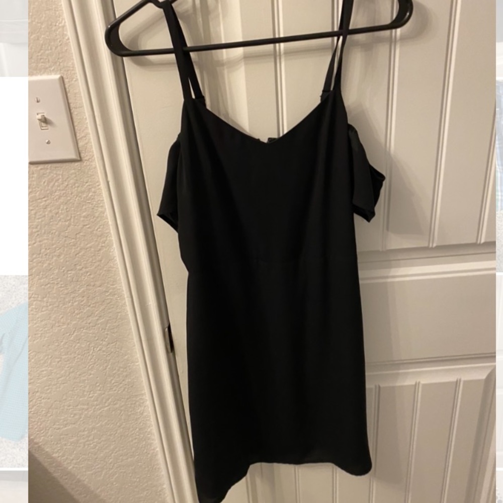Black express dress with sheer off the shoulder sleeve.